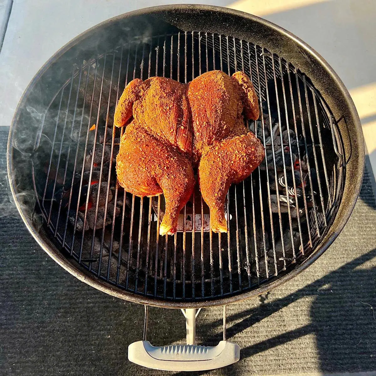 Grilling chicken on charcoal grill
