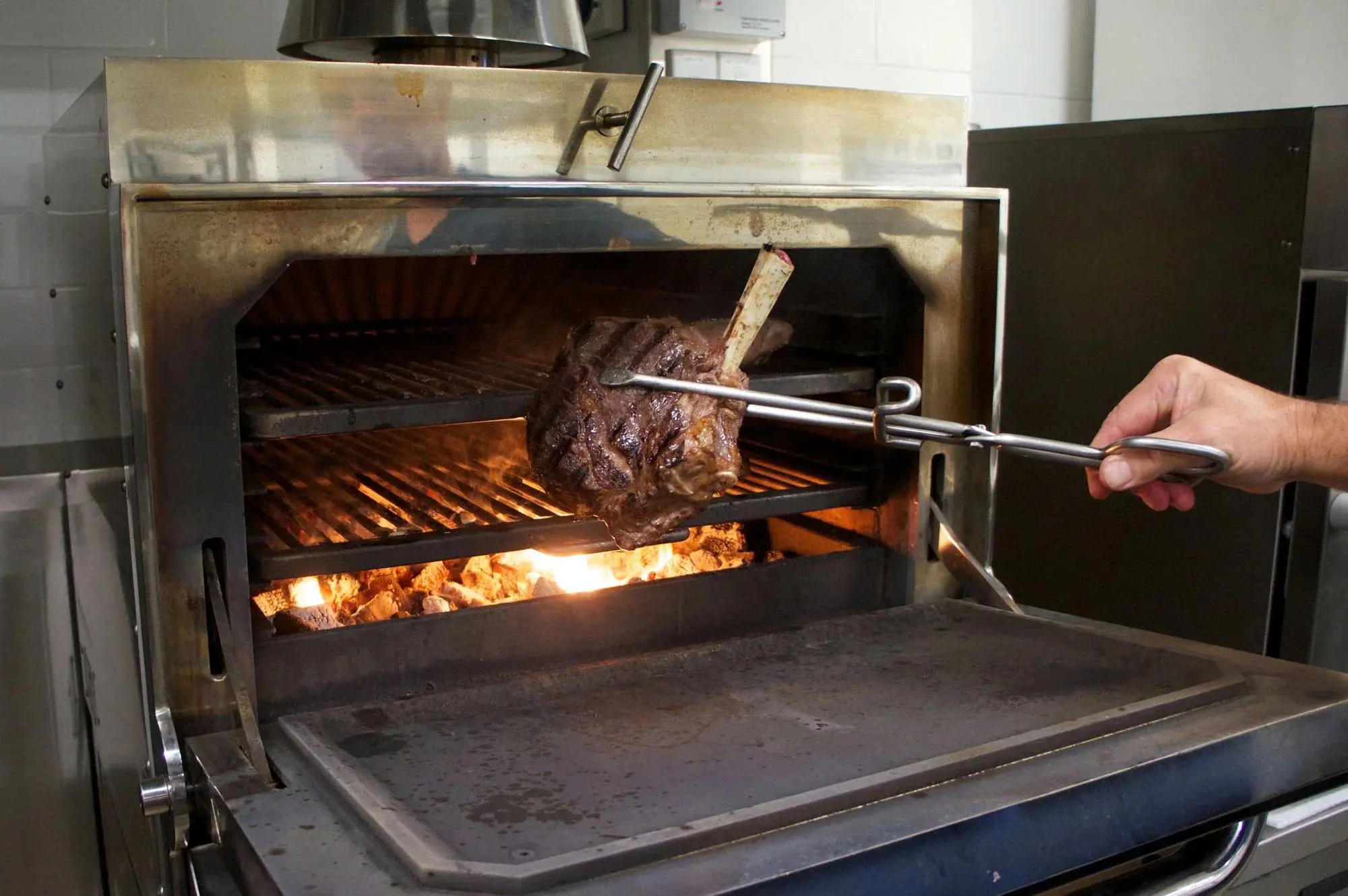 A charcoal oven is a closed-design grill